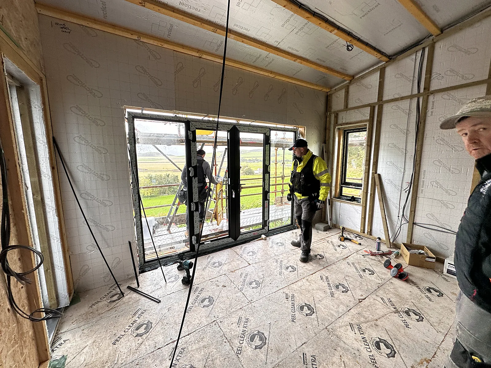 Joiners working inside a timber frame extension