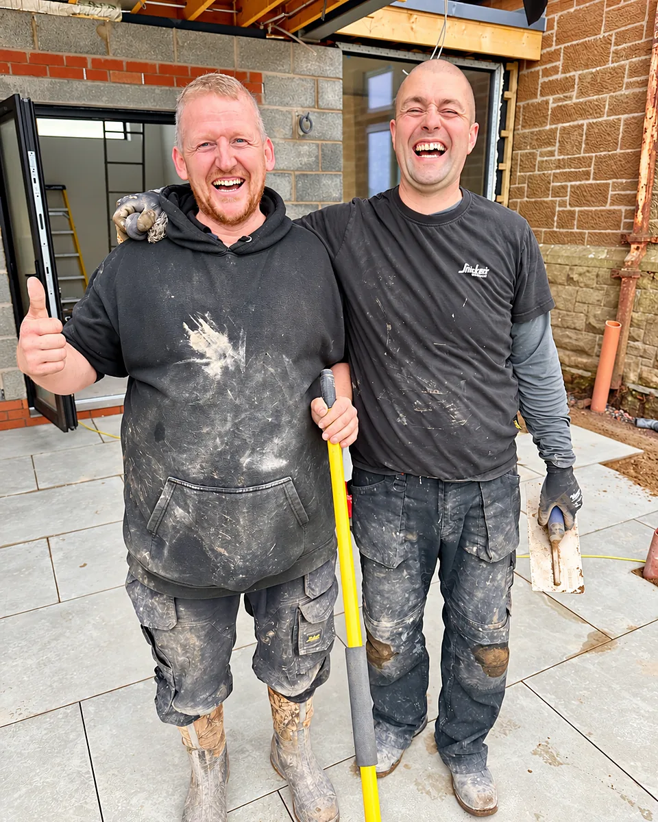 Two of the Cutwood Joinery & Construction team sharing a laugh on site